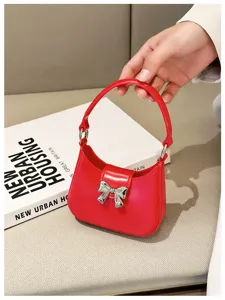 Close-up detail of a vibrant red PVC jelly handbag featuring a silver bow ornament