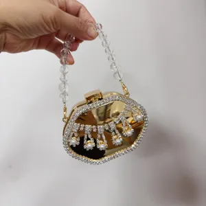 Gold metallic evening clutch bag with crystal beaded handle and pearl tassel detail