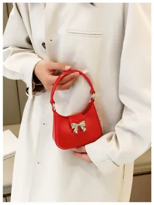 Red bowknot jelly bag detail showing glossy PVC material and silver bow ornament.