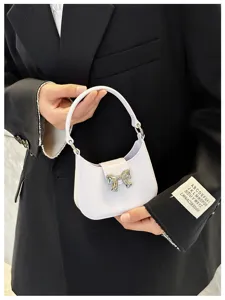 Detailed close-up of a lilac PVC jelly handbag with a stylish silver bow