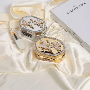 Elegant gold and silver evening clutch bags with pearl floral decor and bead handle.