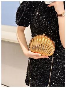 Elegant gold metallic shell-shaped evening clutch bag with delicate chain strap