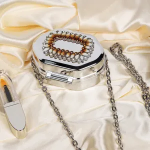 Elegant silver metallic octagonal evening box bag featuring crystal embellishments and chain strap
