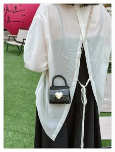 Back view of a mini black PVC jelly bag with heart-shaped lock and gold chain strap