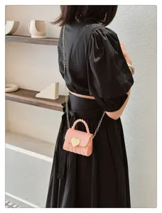 Mini pink PVC jelly bag with gold heart clasp and chain strap, detailed view