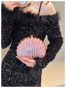 Detail view of the iridescent shell-shaped evening clutch bag with pearlescent finish