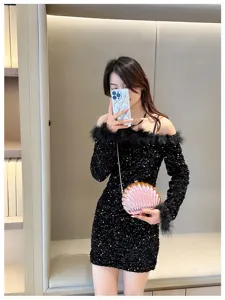 Stylish pink shell-shaped chain crossbody evening bag shown on an elegant model.