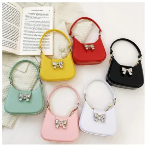 Various colors of mini PVC jelly handbags with decorative metallic bow accents