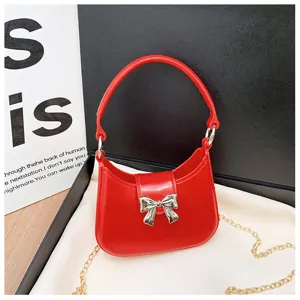 Detailed close-up macro view of a red PVC jelly handbag with a silver bow decoration