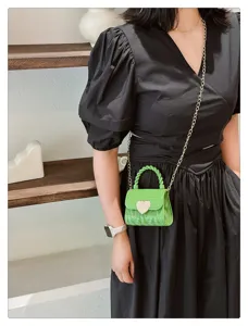 Stylish green mini PVC jelly bag with heart lock and chain strap shown on model