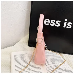 Detail view of a pink PVC jelly bag showing its side profile and golden chain.