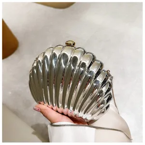 Silver shell-shaped evening clutch bag with metallic finish and chain strap