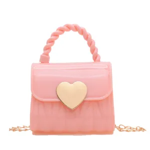 Fashionable pink mini PVC jelly bag featuring a sweet gold heart lock and elegant chain