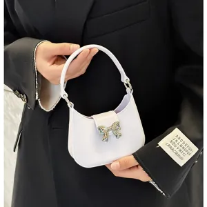 Stylish lavender PVC jelly handbag with a silver bow decoration held by a model