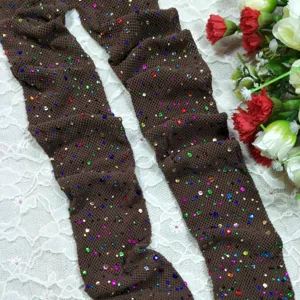 Detail view of brown rhinestone mesh pantyhose, sparkling colorful diamantes on fishnet socks.