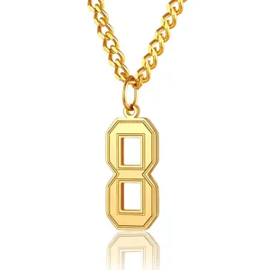 Macro detail view of a golden stainless steel curb chain with a geometric number 8 pendant