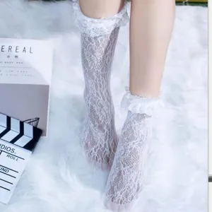 Detail shot of white lace Lolita socks featuring delicate ruffled cuffs and breathable mesh design.