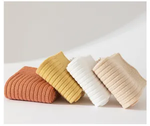 Close-up detail view of solid color ribbed cotton socks in autumn winter soft knit styles.