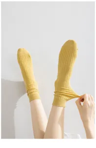 Yellow ribbed cotton mid-tube socks detail view showing elasticity and soft texture close up