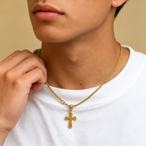 Detailed view of men's stainless steel gold cross pendant necklace on neck