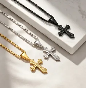 Detail shot of stainless steel cross pendants in black, silver, and gold finishes.