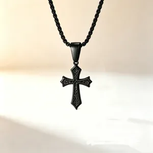 Macro detail of black stainless steel cross pendant with intricate engraved patterns