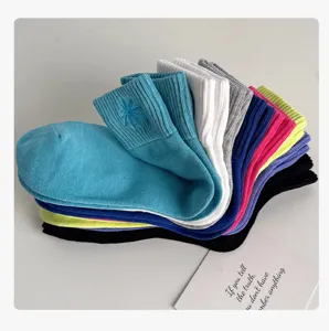 Colorful dopamine mid-calf cotton socks with embroidered leaf design, soft and comfortable.