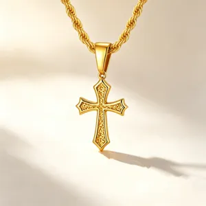 Detailed close-up of a golden stainless steel cross pendant with floral engraving