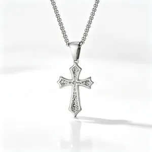 Close-up of a silver stainless steel cross pendant necklace with intricate patterns