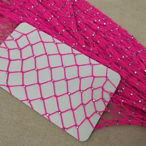 Detail view of hot pink rhinestone fishnet stockings mesh material, sparkly diamond mesh fabric.
