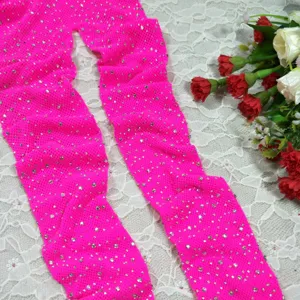 Neon pink rhinestone fishnet tights detail close up view for women fashion wear style.