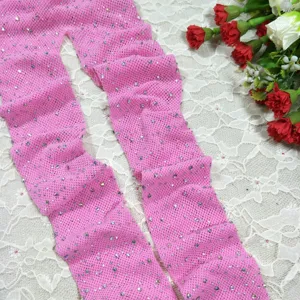 Pink rhinestone fishnet pantyhose detail view, showing sparkling crystal stones on mesh fabric.