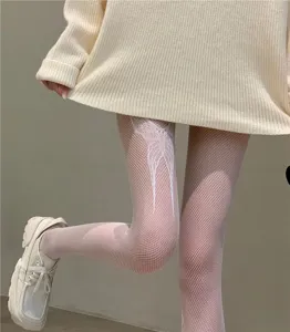 Detailed view of white fishnet tights featuring a delicate butterfly pattern design on the upper leg.