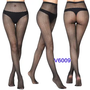 Detailed view of women's black fishnet pantyhose, mesh jacquard pattern sexy tights close-up.