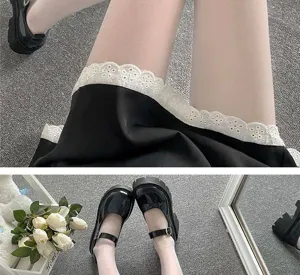 Detailed view of white sheer pantyhose paired with black JK skirt and Mary Jane shoes.