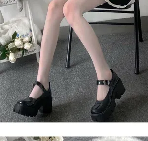 Detailed shot of women white pantyhose and black platform Mary Jane shoes, stylish gothic look.