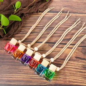 Colorful hanging car perfume bottles with wooden caps and ropes, detailed view of aroma diffusers.