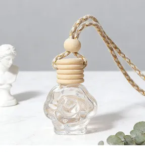 Detailed close-up shot of the rose-shaped car perfume glass bottle with a wooden cap and rope.