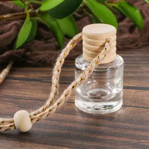 Empty car perfume bottle glass essential oil diffuser pendant with wooden cap and hanging rope.