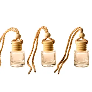 Hanging car perfume glass empty bottle with wooden cap and braided rope for vehicle interior decor.