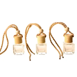 Detail view of a 6ml square glass car perfume bottle featuring a wooden cap and braided hanging rope.
