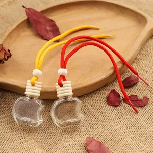 Transparent apple shaped glass car perfume bottle with wooden cap and colorful rope.