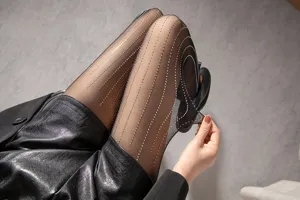 Detail view of black sheer pantyhose with sparkling rhinestone vertical stripes and stretch.