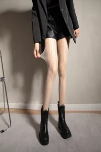 Detail shot of sheer vertical rhinestone tights, sparkly hosiery showcasing elasticity and glitter design.