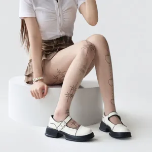 Detail shot of Lolita white tights featuring cute star and heart tattoo prints for women.