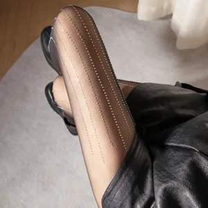 Sheer black pantyhose featuring sparkling rhinestone vertical stripes for a chic sexy look.