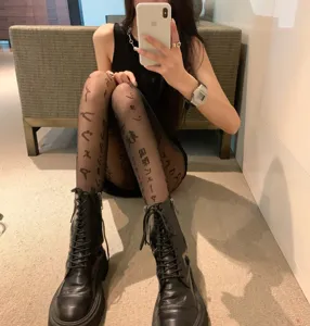 Black sheer tights featuring Japanese letter prints, offering a sexy and stylish look for daily wear.