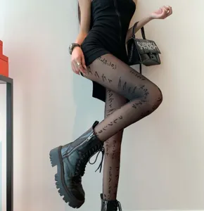 Detailed close-up of fashionable sheer black tights featuring stylish Japanese letter prints.