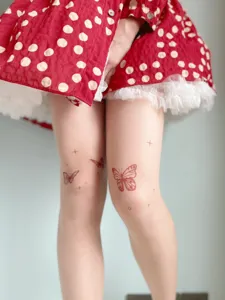 Sheer skin-colored tights featuring cute wine red butterfly and star tattoo prints for women.