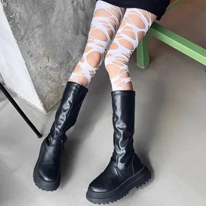 White gothic cut-out hollow-out tights paired with black platform boots for alternative punk style.